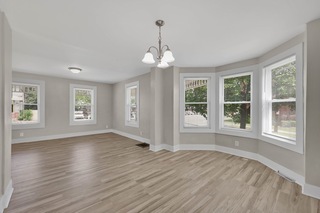 171 Boston Road Springfield, MA 01109 - Photo 13 of 33 a view of an empty room with wooden floor and a window