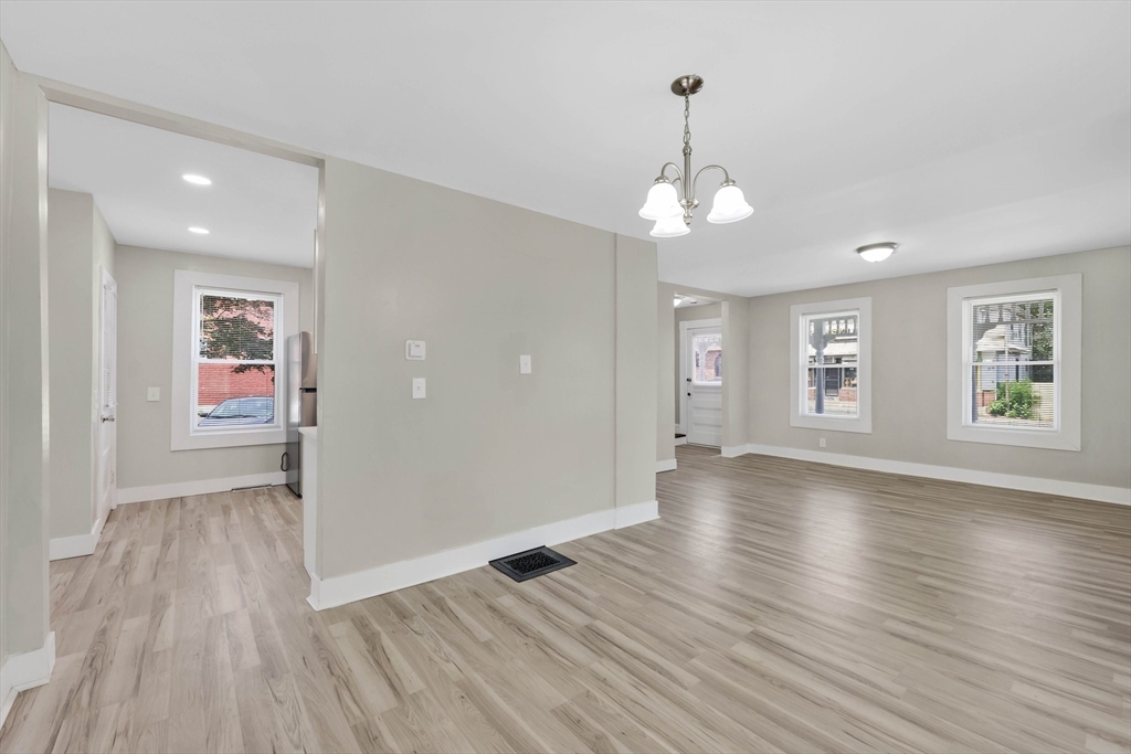 171 Boston Road Springfield, MA 01109 - Photo 14 of 33 an empty room with wooden floor and windows
