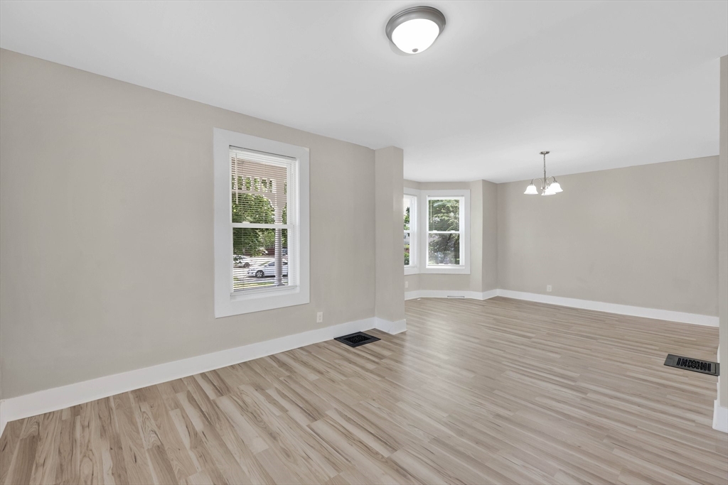 171 Boston Road Springfield, MA 01109 - Photo 16 of 33 an empty room with wooden floor and windows