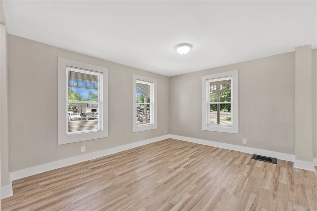 171 Boston Road Springfield, MA 01109 - Photo 17 of 33 a view of an empty room with wooden floor and a window