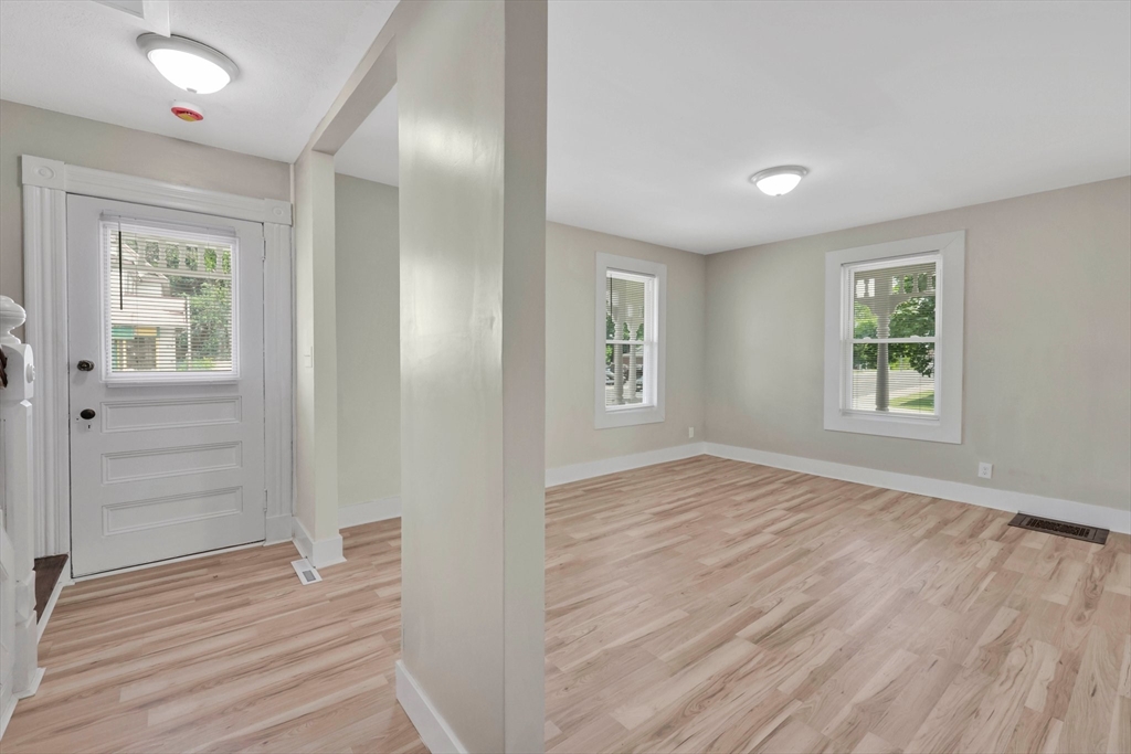 171 Boston Road Springfield, MA 01109 - Photo 18 of 33 an empty room with wooden floor and windows