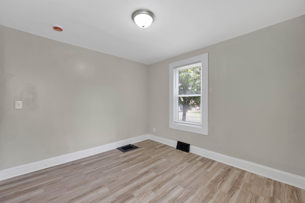 171 Boston Road Springfield, MA 01109 - Photo 23 of 33 an empty room with wooden floor and windows