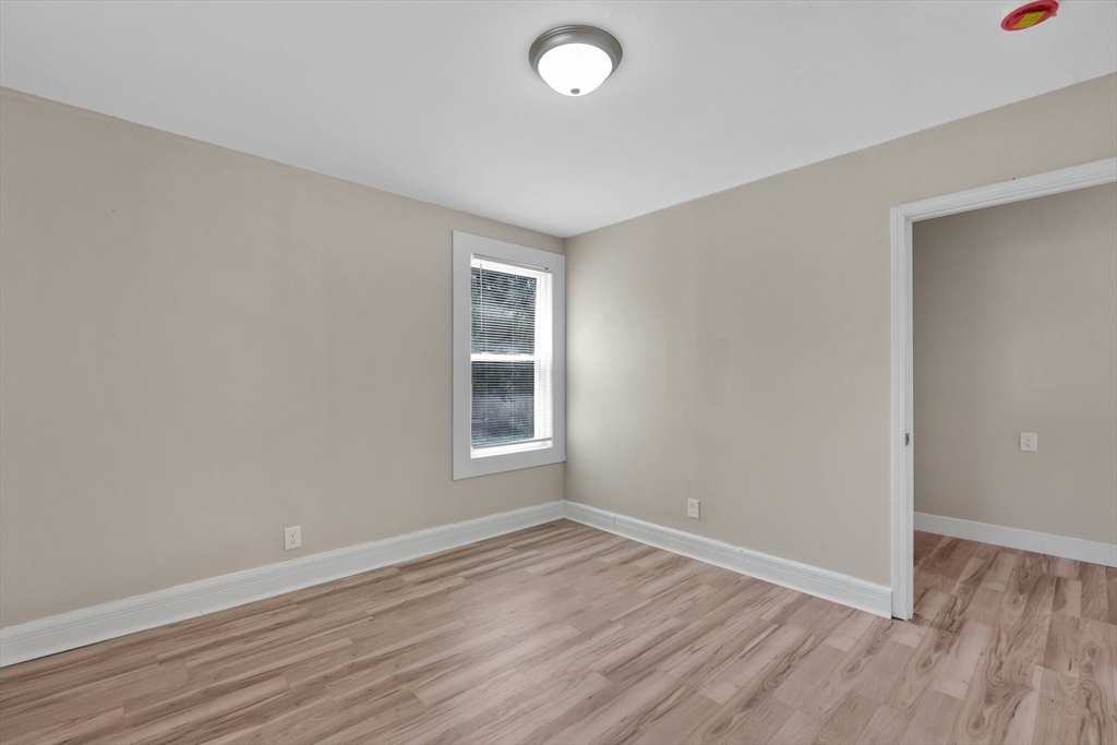 171 Boston Road Springfield, MA 01109 - Photo 24 of 33 an empty room with wooden floor and windows