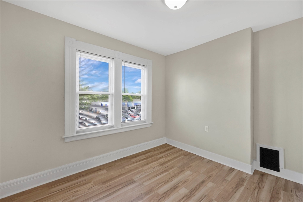171 Boston Road Springfield, MA 01109 - Photo 27 of 33 an empty room with wooden floor and windows