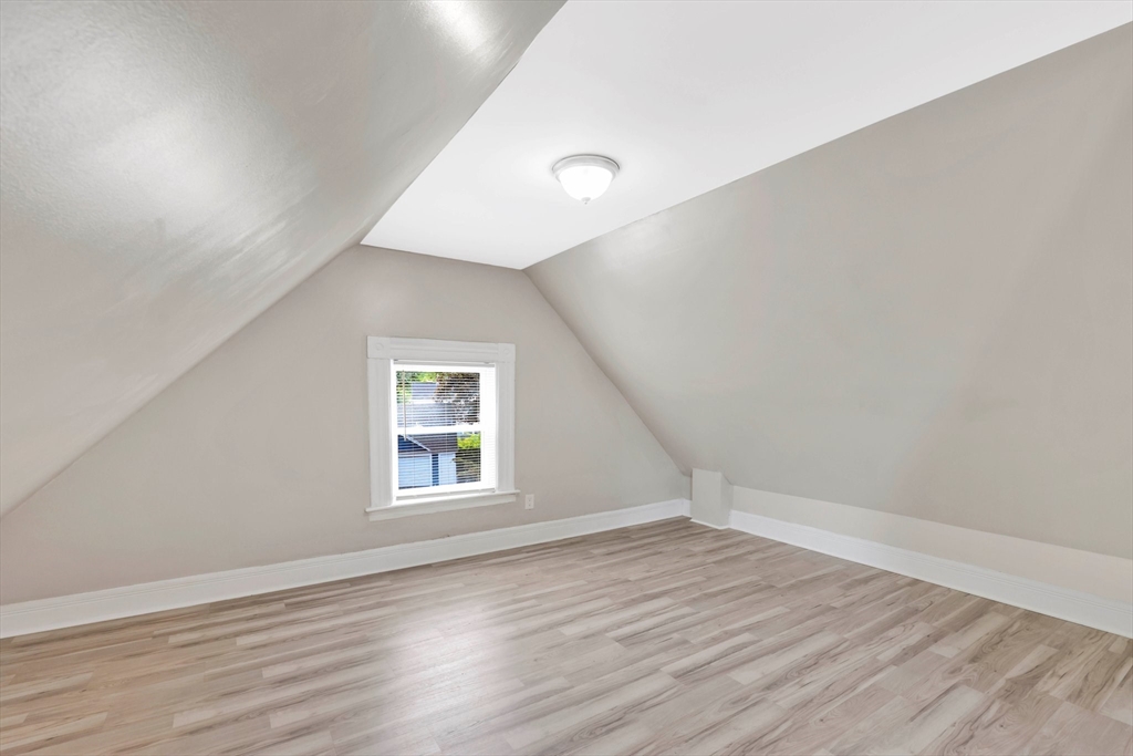 171 Boston Road Springfield, MA 01109 - Photo 30 of 33 an empty room with wooden floor and windows