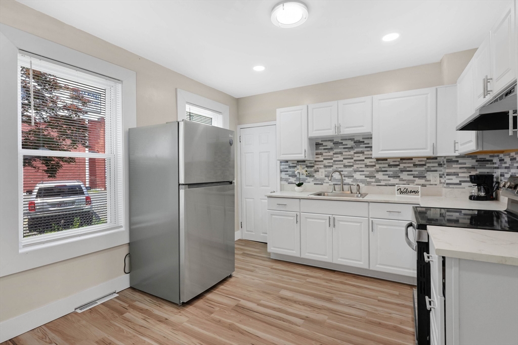 171 Boston Road Springfield, MA 01109 - Photo 8 of 33 a kitchen with stainless steel appliances granite countertop a refrigerator and a stove top oven