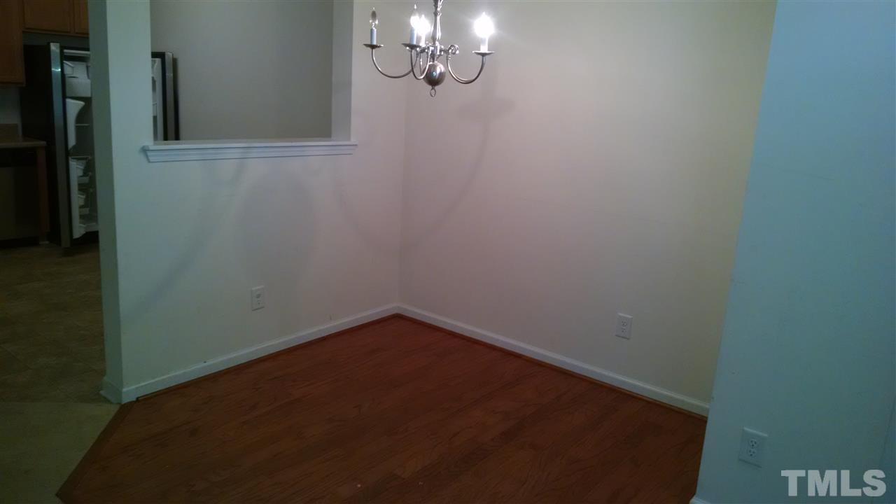 401 Coalinga Lane, Unit 102 Raleigh, NC 27610 - Photo 11 of 12 a view of a small space with wooden floor and a window