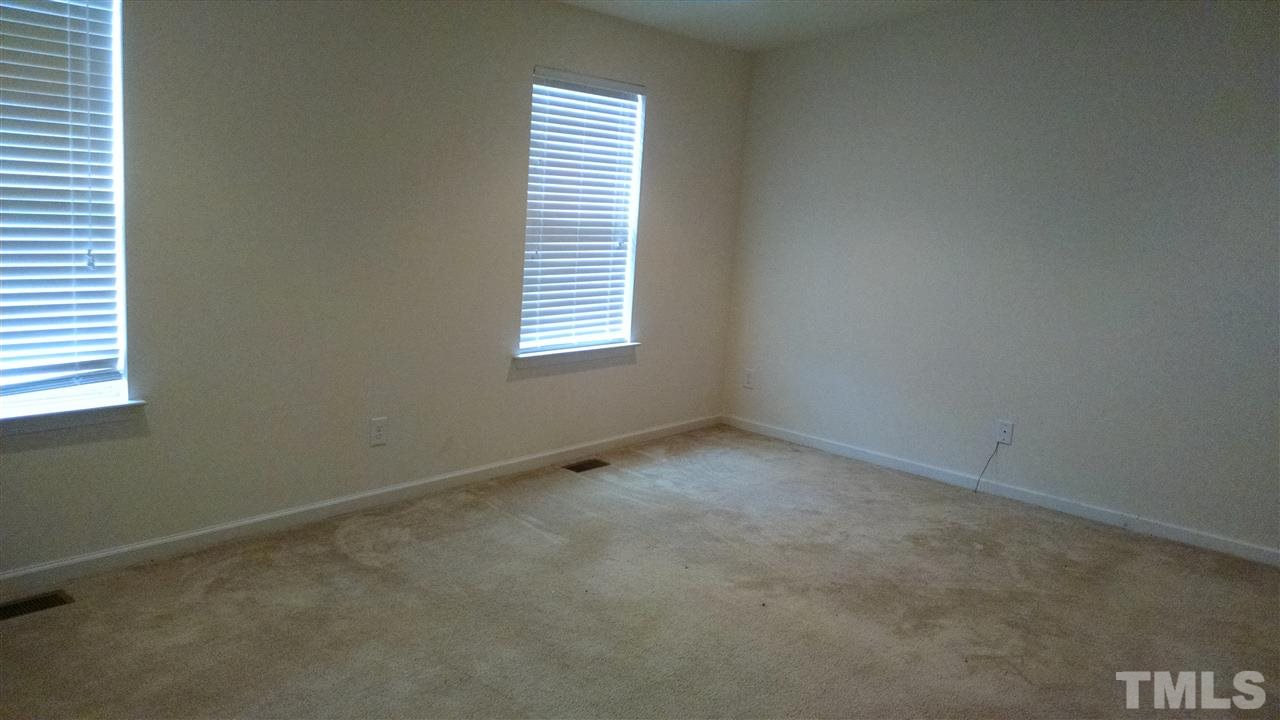 401 Coalinga Lane, Unit 102 Raleigh, NC 27610 - Photo 6 of 12 an empty room with a window