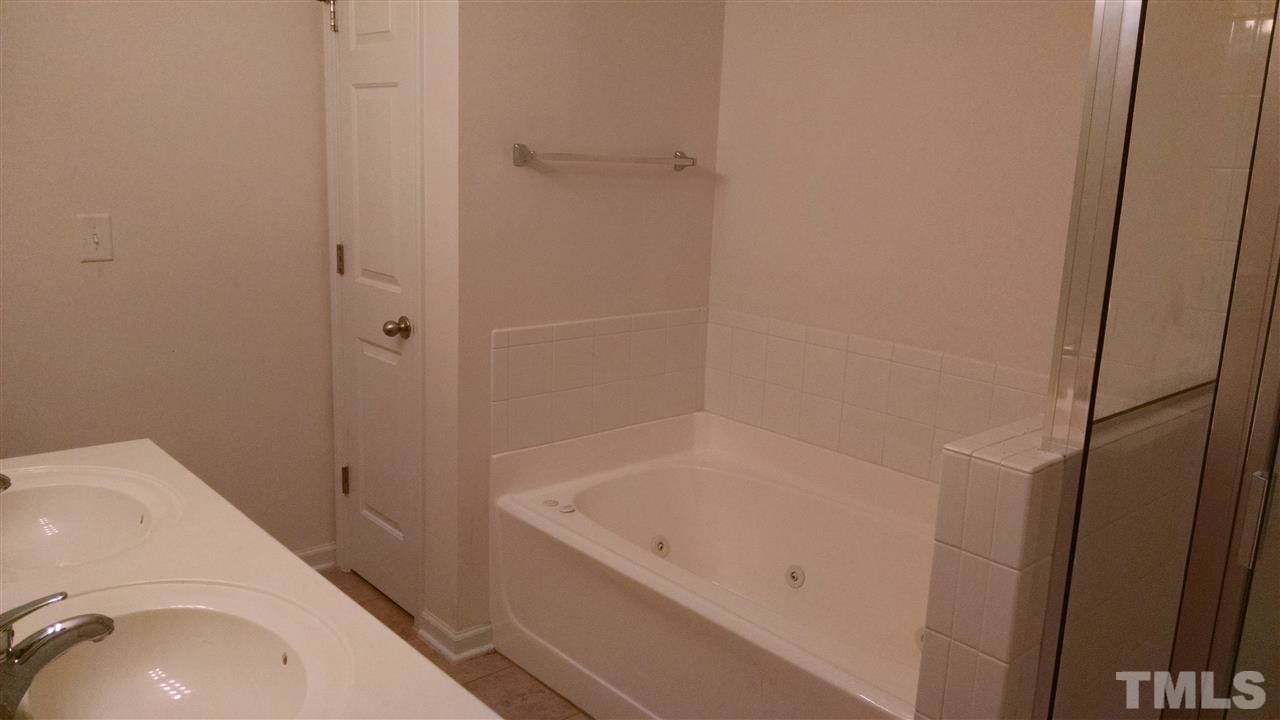 401 Coalinga Lane, Unit 102 Raleigh, NC 27610 - Photo 7 of 12 a bathroom with a sink and bathtub