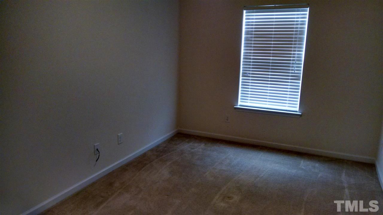 401 Coalinga Lane, Unit 102 Raleigh, NC 27610 - Photo 10 of 12 an empty room with a window