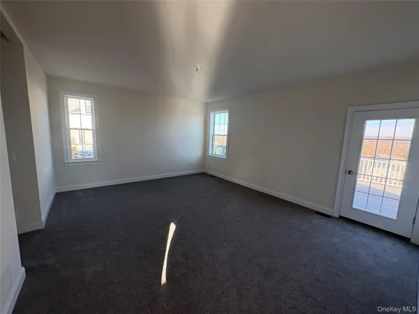 a spacious bathroom with double vanity and a mirror