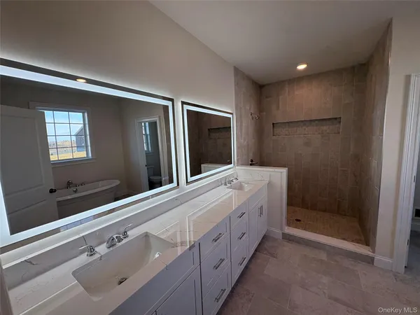 a bathroom with a tub a toilet and a shower