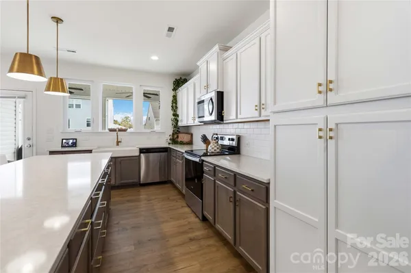a kitchen with stainless steel appliances granite countertop lots of counter top space and cabinets