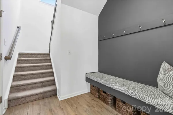 a view of entryway with stairs and wooden floor