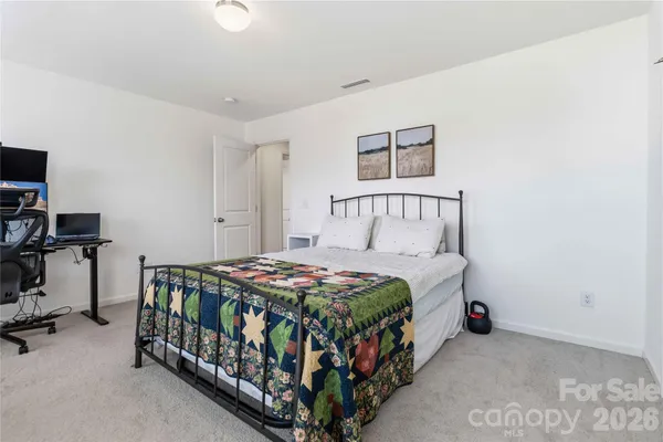a bedroom with a bed and a tv