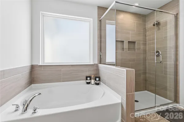a bathroom with a bathtub and a shower