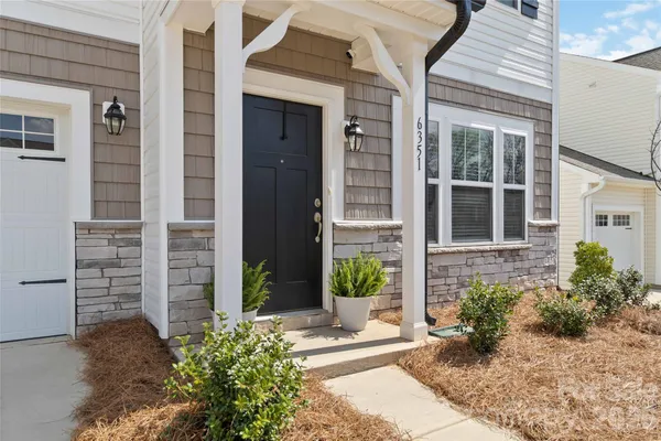 front view of a house with potted plants