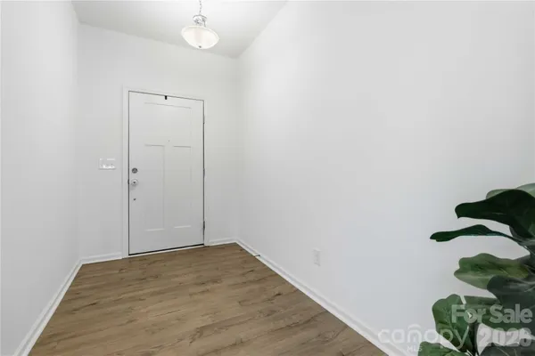 a view of a room with wooden floor