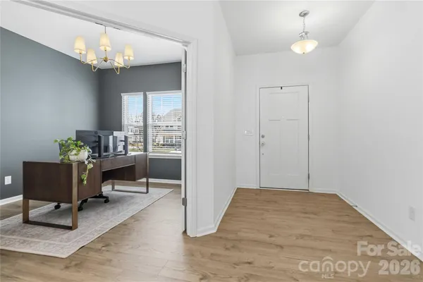 a view of a livingroom with furniture and a chandelier