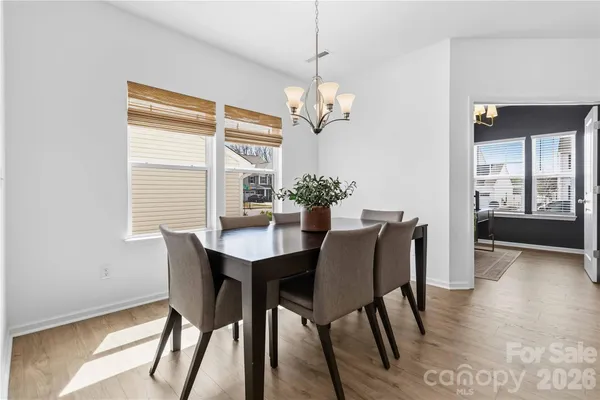 a view of a dining room with furniture wooden floor and chandelier