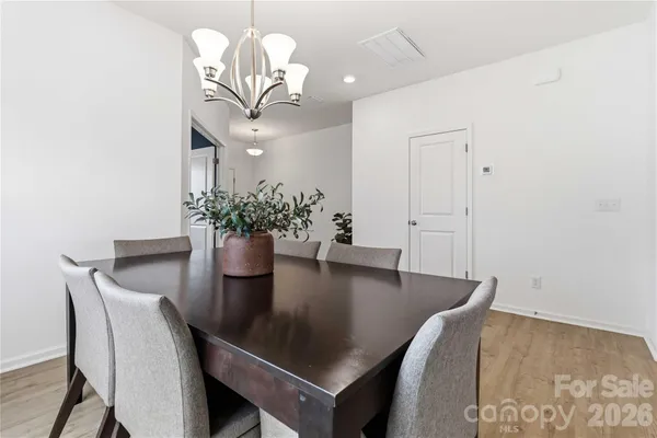 a dining room with table and chairs