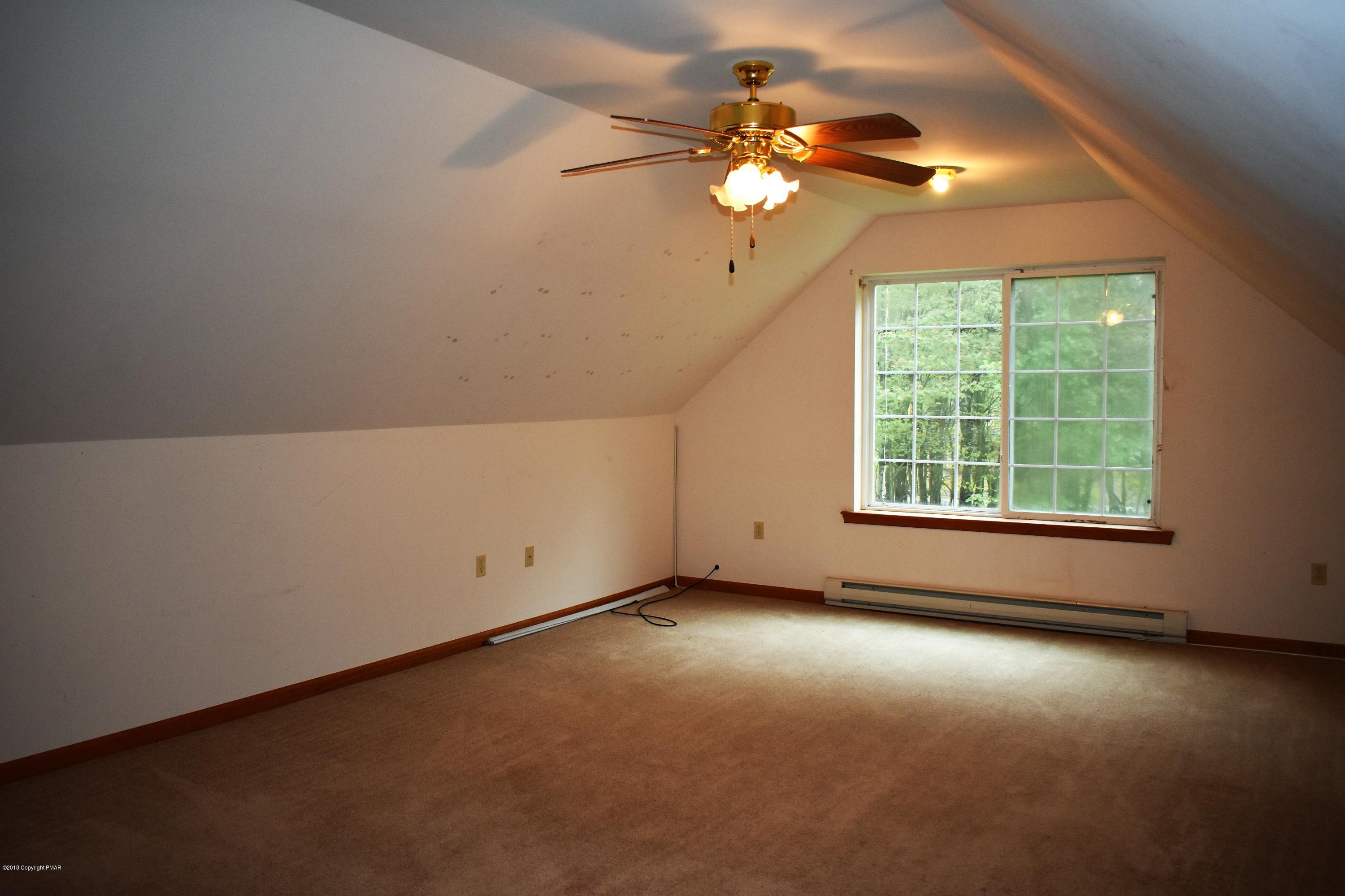 33 Sassafras Road Albrightsville, PA 18210 - Photo 15 of 36 an empty room with windows and chandelier fan