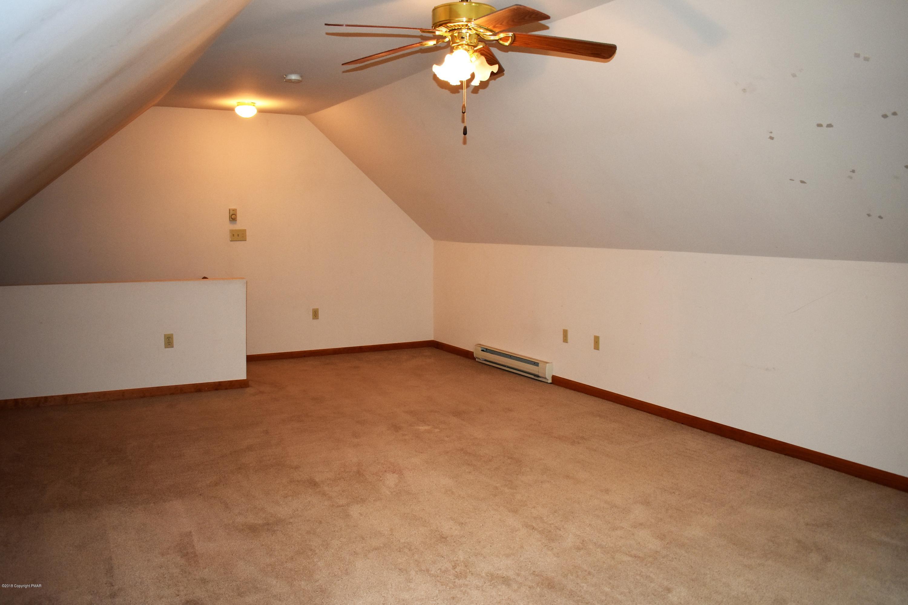 33 Sassafras Road Albrightsville, PA 18210 - Photo 16 of 36 en empty room with ceiling fan and window