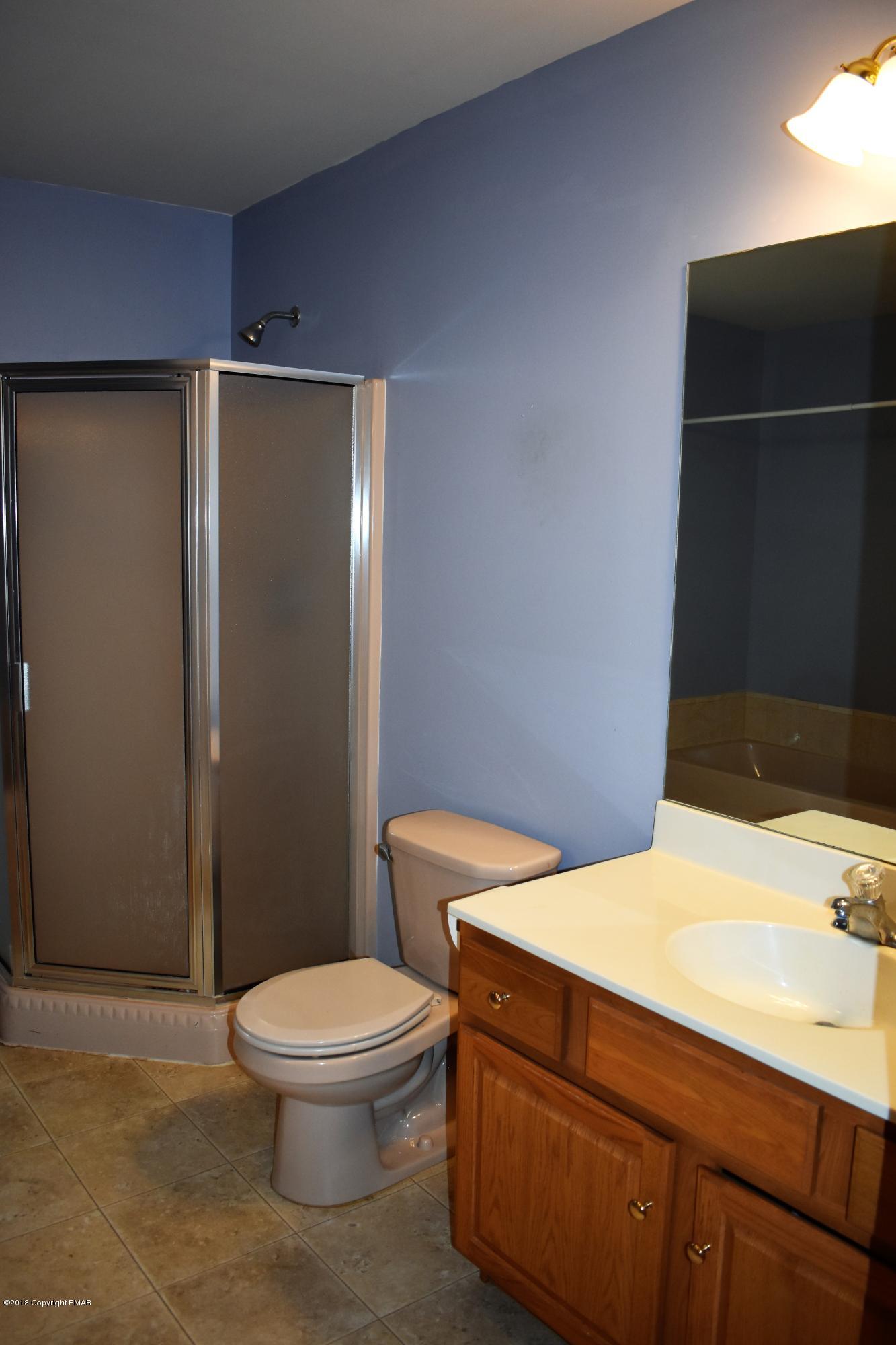33 Sassafras Road Albrightsville, PA 18210 - Photo 22 of 36 a bathroom with a toilet a sink and wooden floor