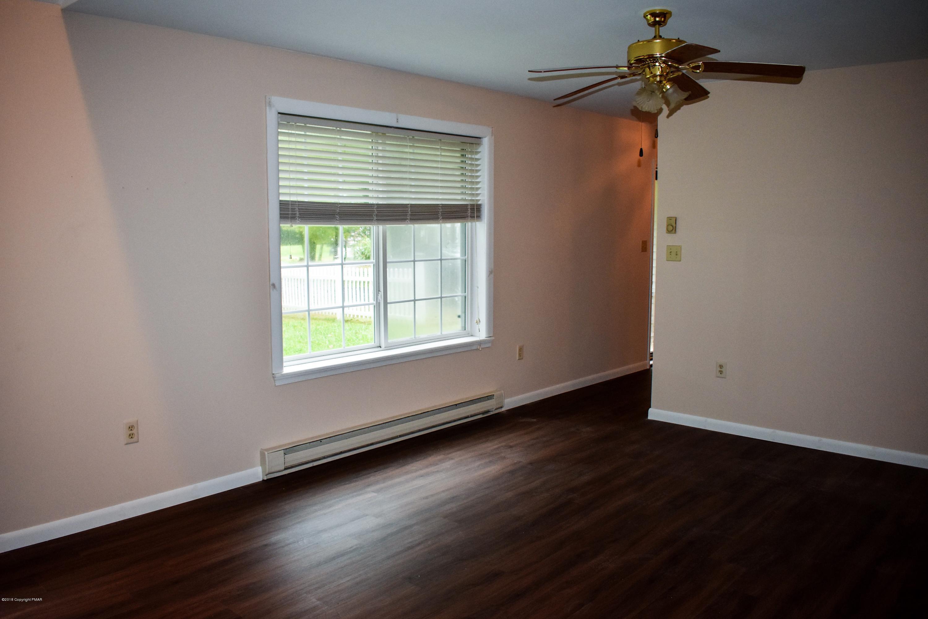 33 Sassafras Road Albrightsville, PA 18210 - Photo 6 of 36 a view of an empty room with wooden floor and a window