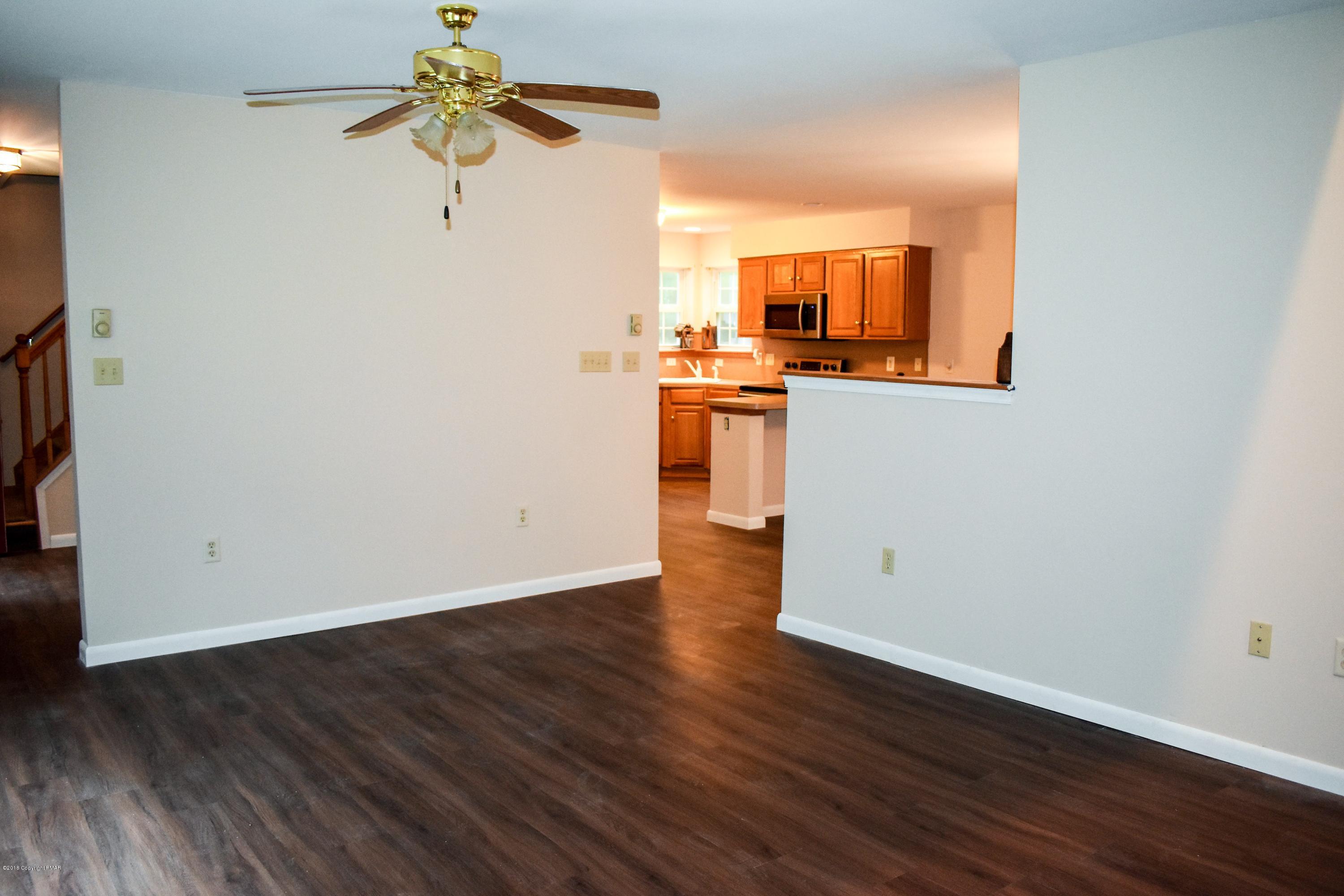 33 Sassafras Road Albrightsville, PA 18210 - Photo 7 of 36 a view of a kitchen with wooden floor and a ceiling fan