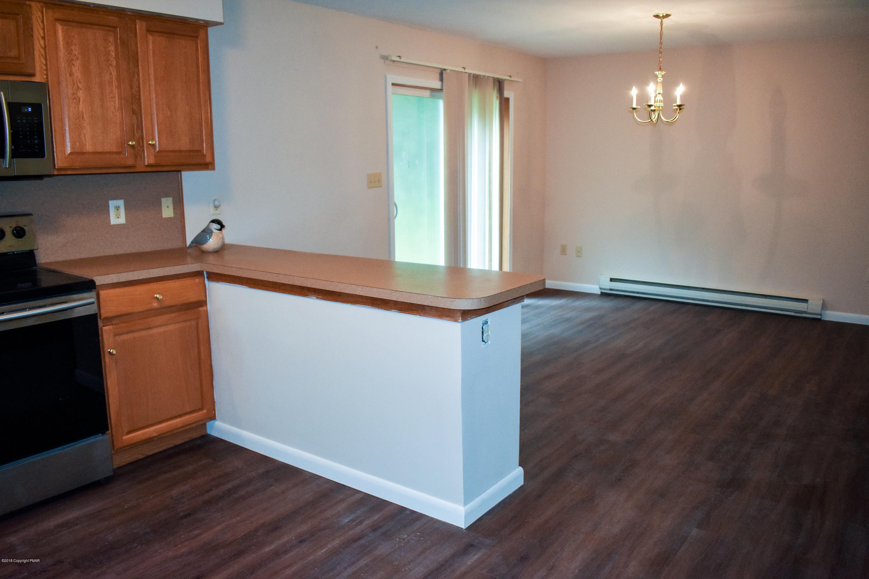 33 Sassafras Road Albrightsville, PA 18210 - Photo 10 of 36 a kitchen with granite countertop wooden floors and white walls