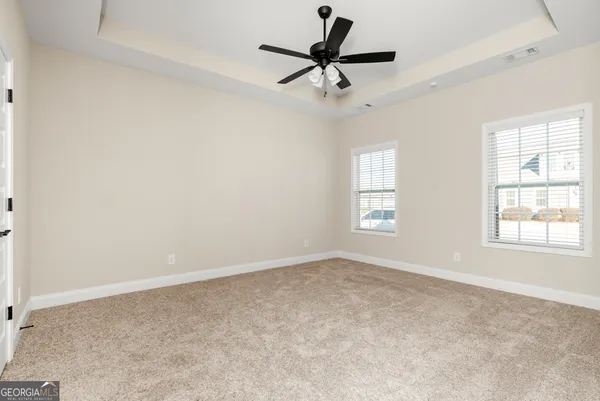 a view of a livingroom with a ceiling fan and wooden floor