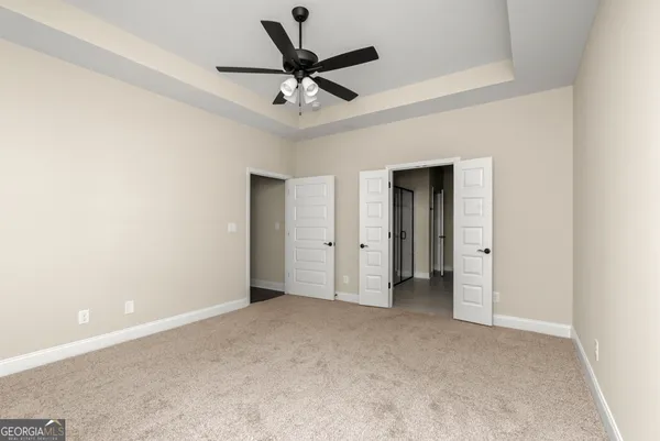 a bathroom with a granite countertop sink a mirror and shower