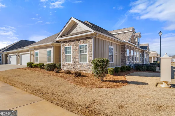a view of a house with snow on the road