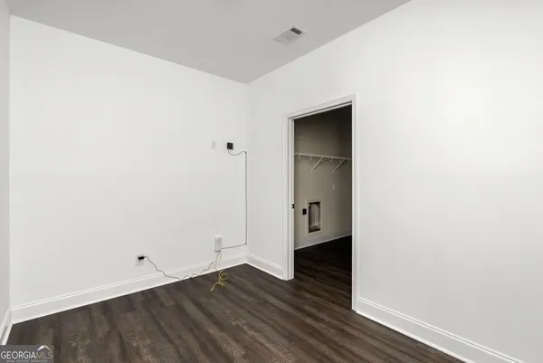a view of a small space with wooden floor and a sink