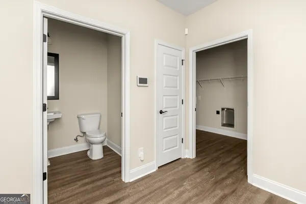 an empty room with wooden floor & closet