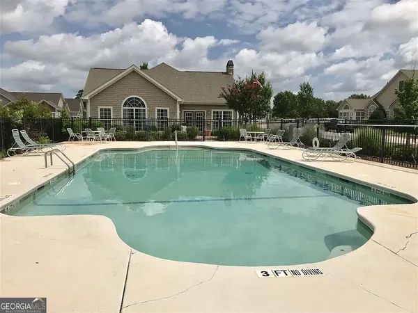a view of a swimming pool with a yard