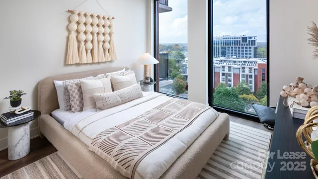 a bedroom with a bed and a large window