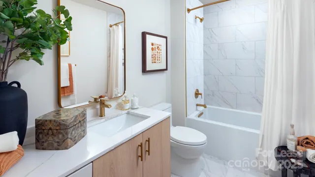 a bathroom with a granite countertop sink toilet a mirror and shower