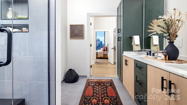 a en suite bathroom with a granite countertop sink and a mirror