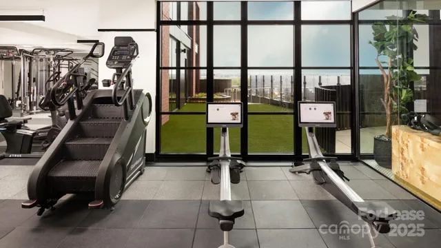 a room with gym equipment and large mirror