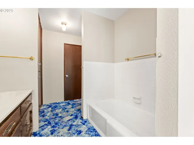 a bathroom with a bathtub and a sink