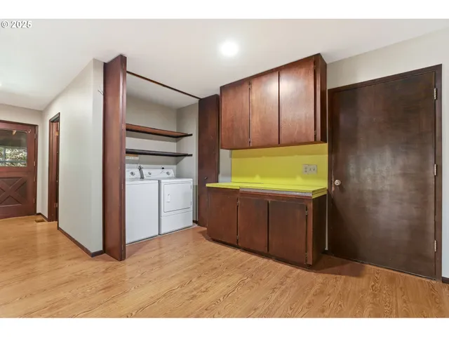 a kitchen with stainless steel appliances kitchen island granite countertop a refrigerator and a sink