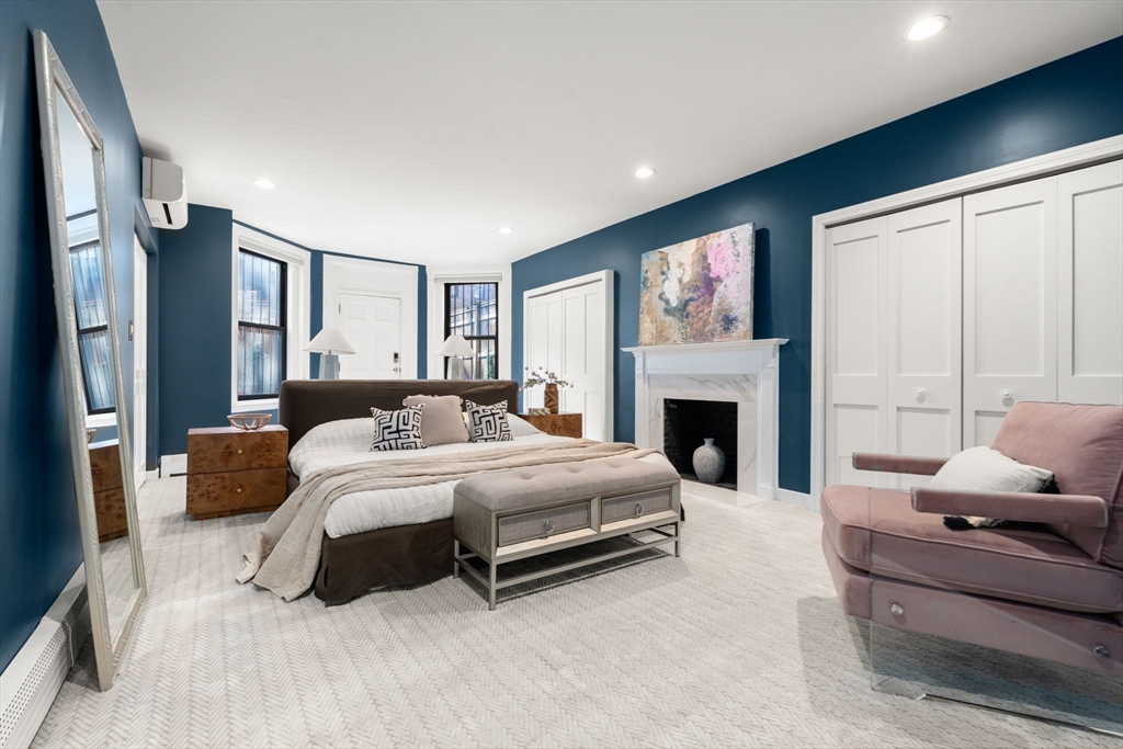 457 Beacon Street, Unit 5 Boston, MA 02115 - Photo 14 of 22 a spacious bedroom with a large bed and a fireplace