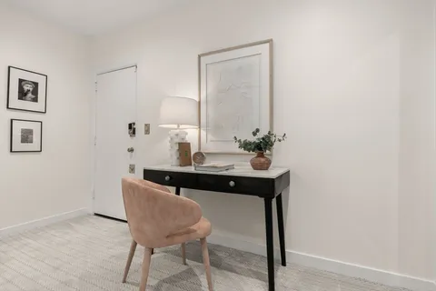 a view of a room with a table and chairs