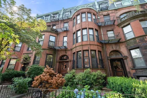 a picture of a book and a white bed