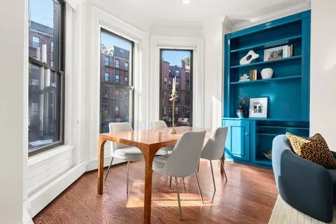 a dining room with furniture and wooden floor