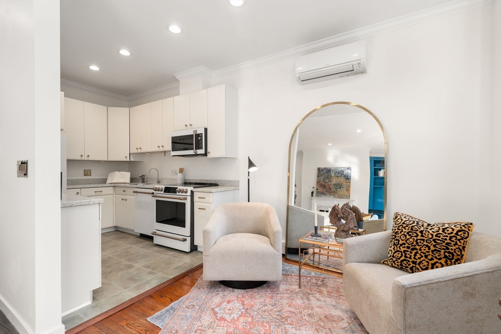 457 Beacon Street, Unit 5 Boston, MA 02115 - Photo 8 of 22 a living room with furniture and a fireplace