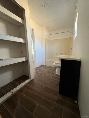 a room with a wooden floor and cabinets