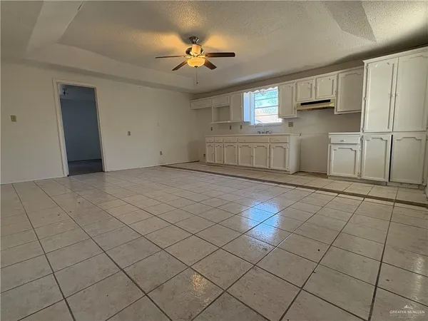 a view of a kitchen with cabinets and stainless steel appliances